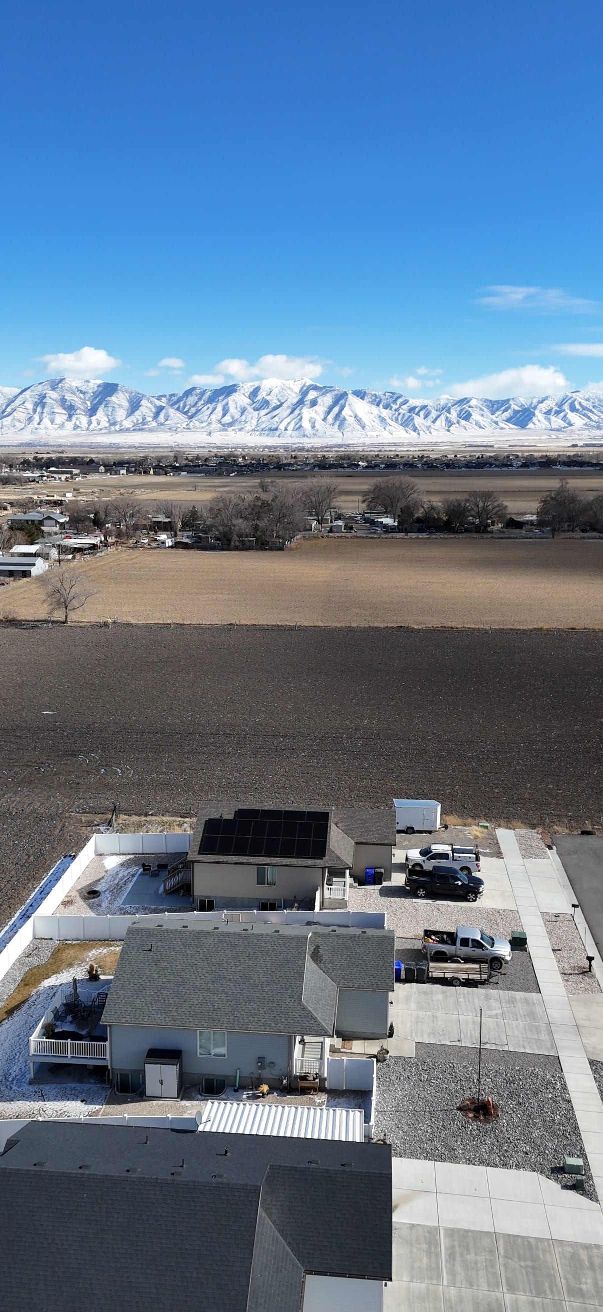 [Trina panels] Aerial drone shot showing full installation with snowy mountains