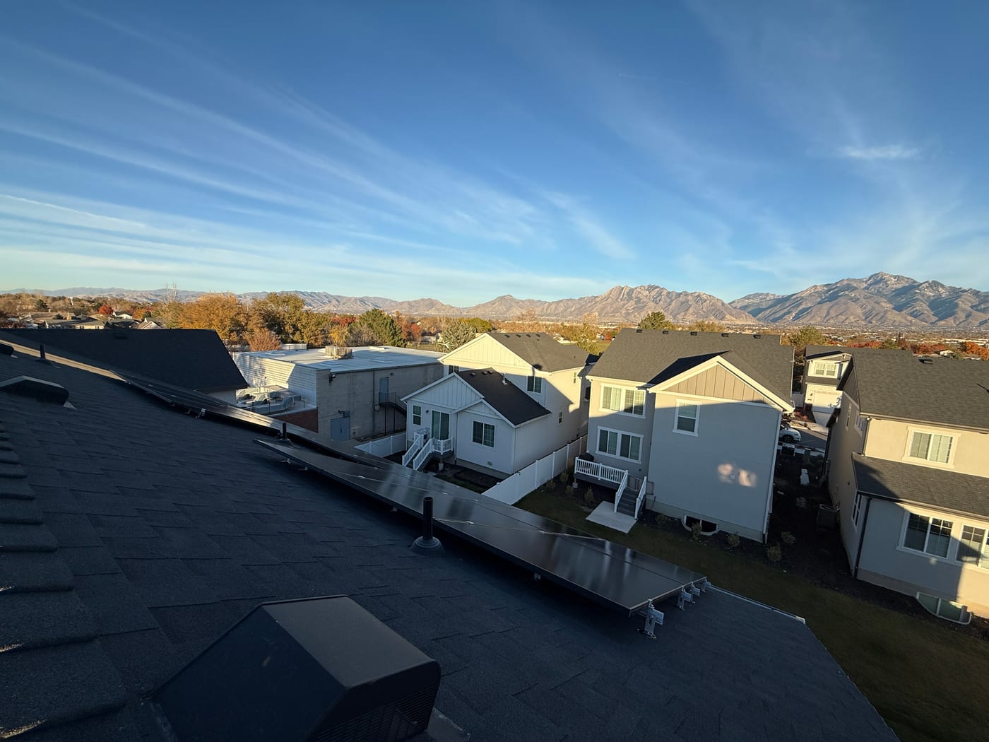 [Tier 1 Trina panels] From roof ridge showing solar panels with racking and stunning Wasatch mountain panorama in background