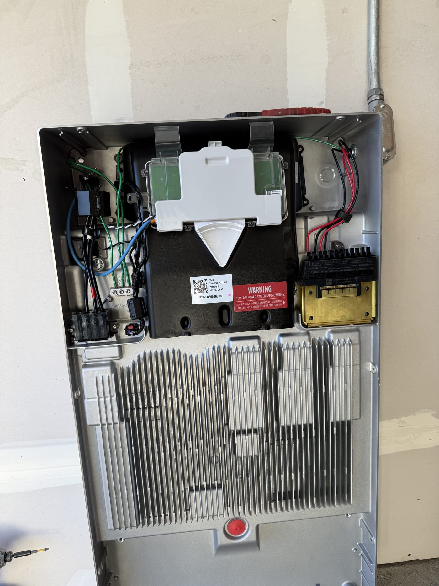 Tesla Powerwall 3 interior showing circuit board heat sink and wiring connections
